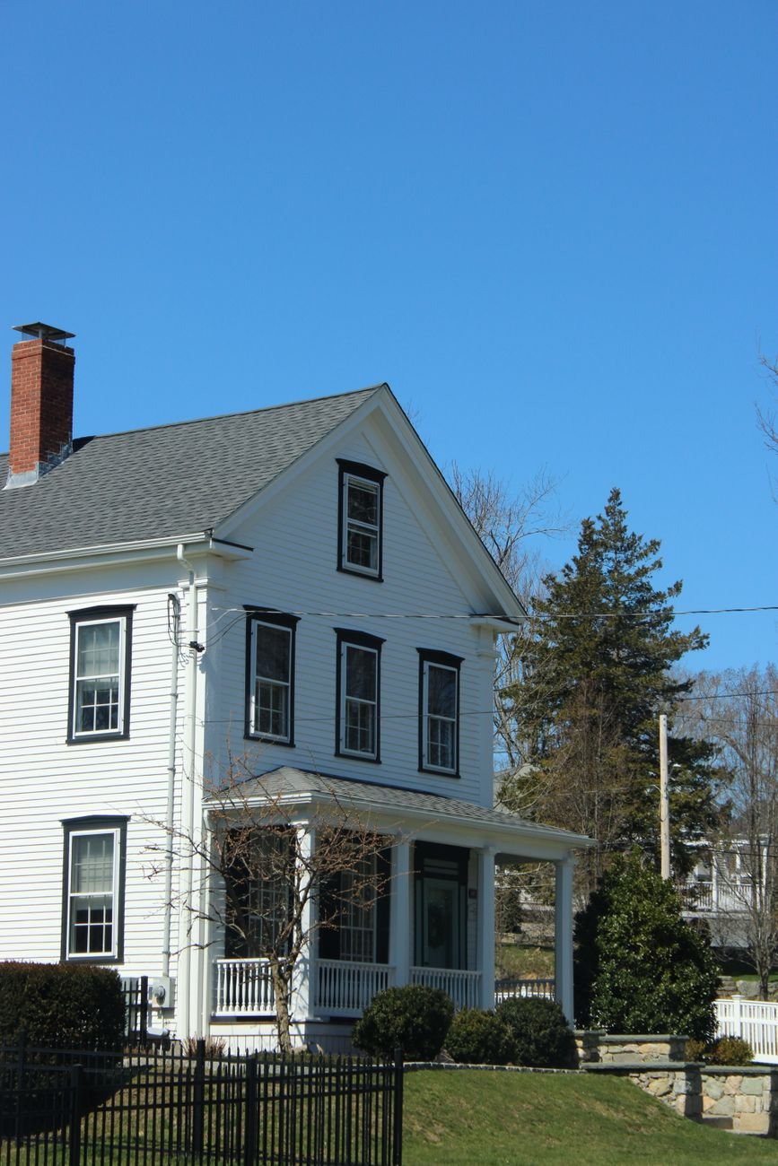 White colonial-style house in Massachusetts, representative of the area’s older housing stock