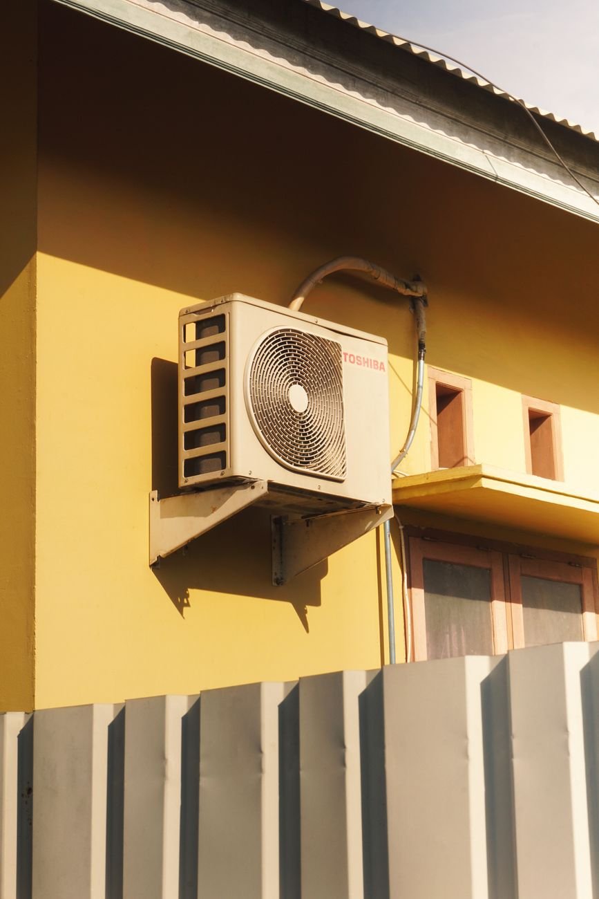Outdoor mini-split condenser unit mounted on a residential exterior
