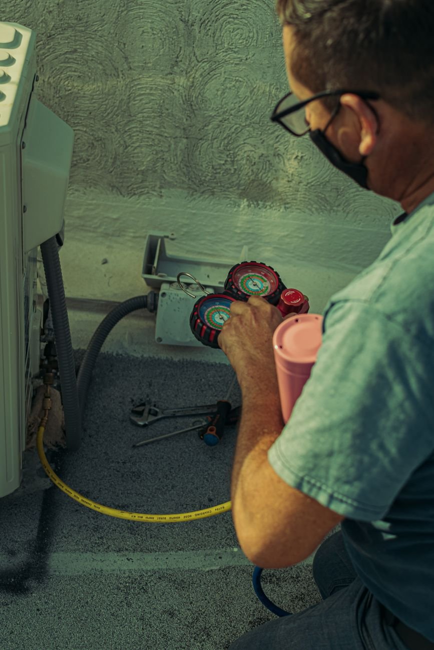 HVAC technician repairing an outdoor ductless unit