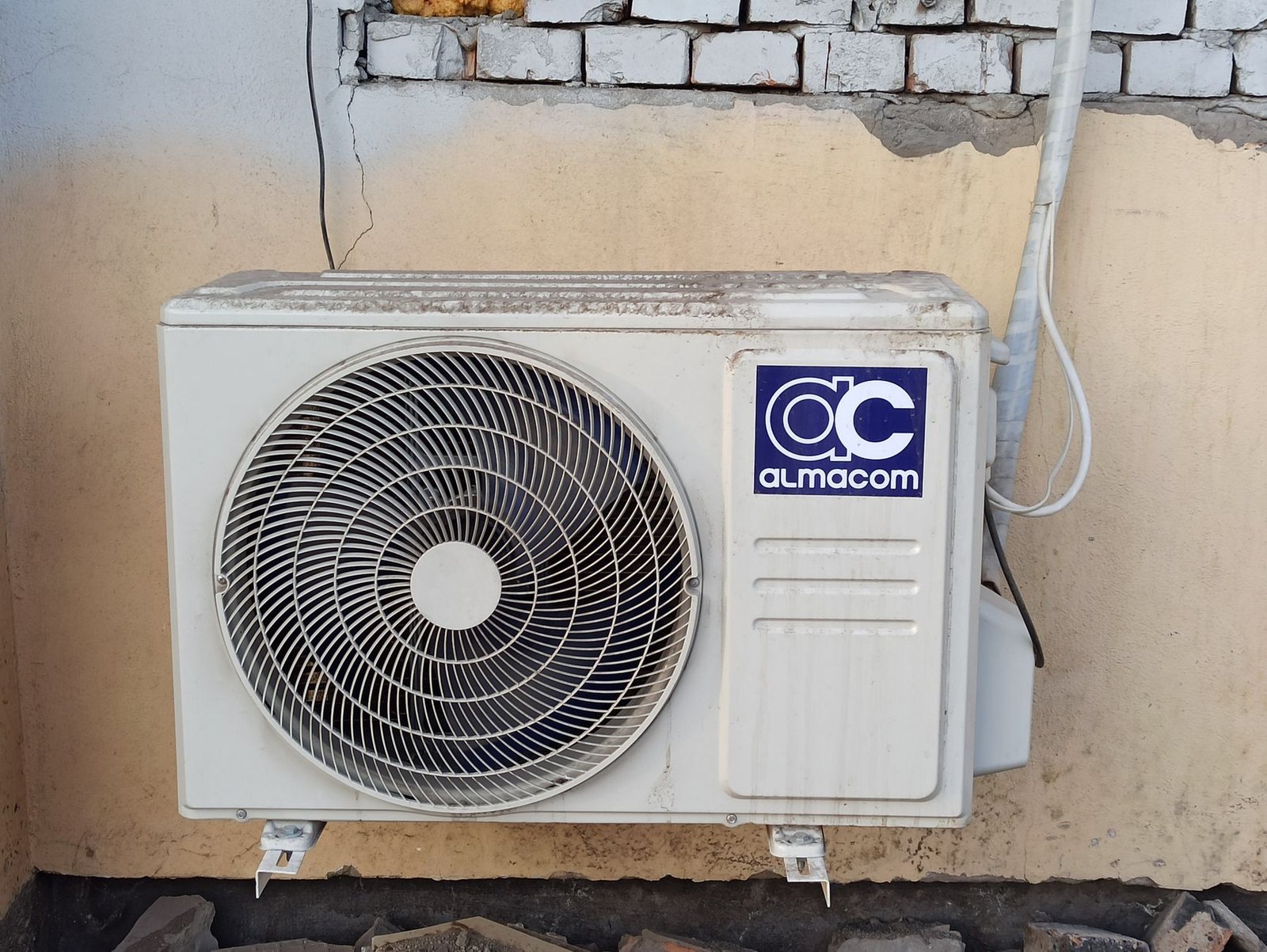 Ductless mini-split wall unit mounted on a brick exterior